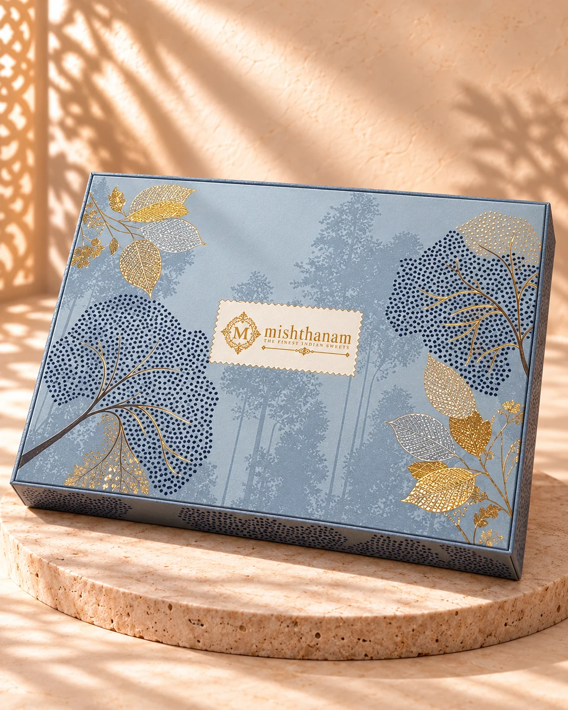 Powder-blue Diwali gift box with delicate navy and gold botanical artwork
